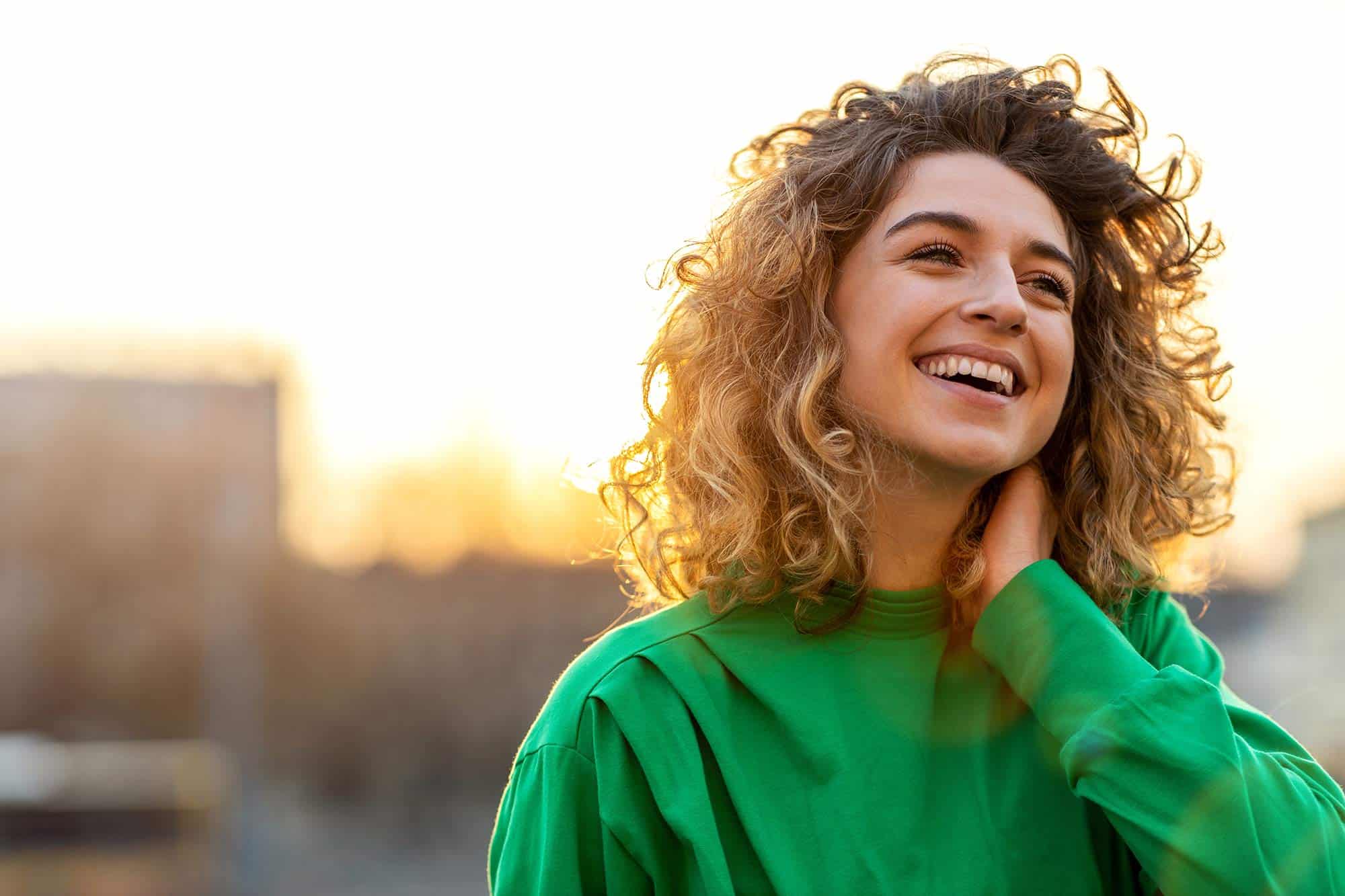 Pelvic Health Services | Woman smiling with city background | SOPTRI | Specialized Orthopedic Physical Therapy